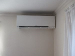 Indoor installation of Mitsubishi ductless Hyper-Heating heat pump unit.